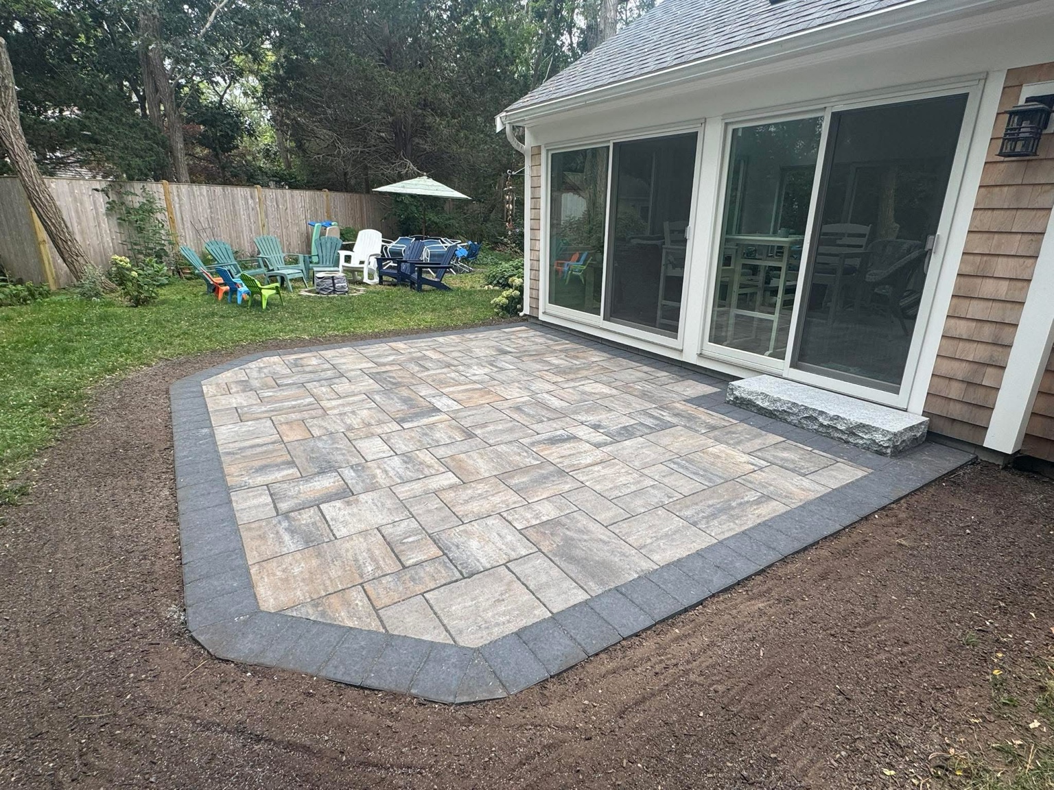 Backyard paver patio with contrasting border