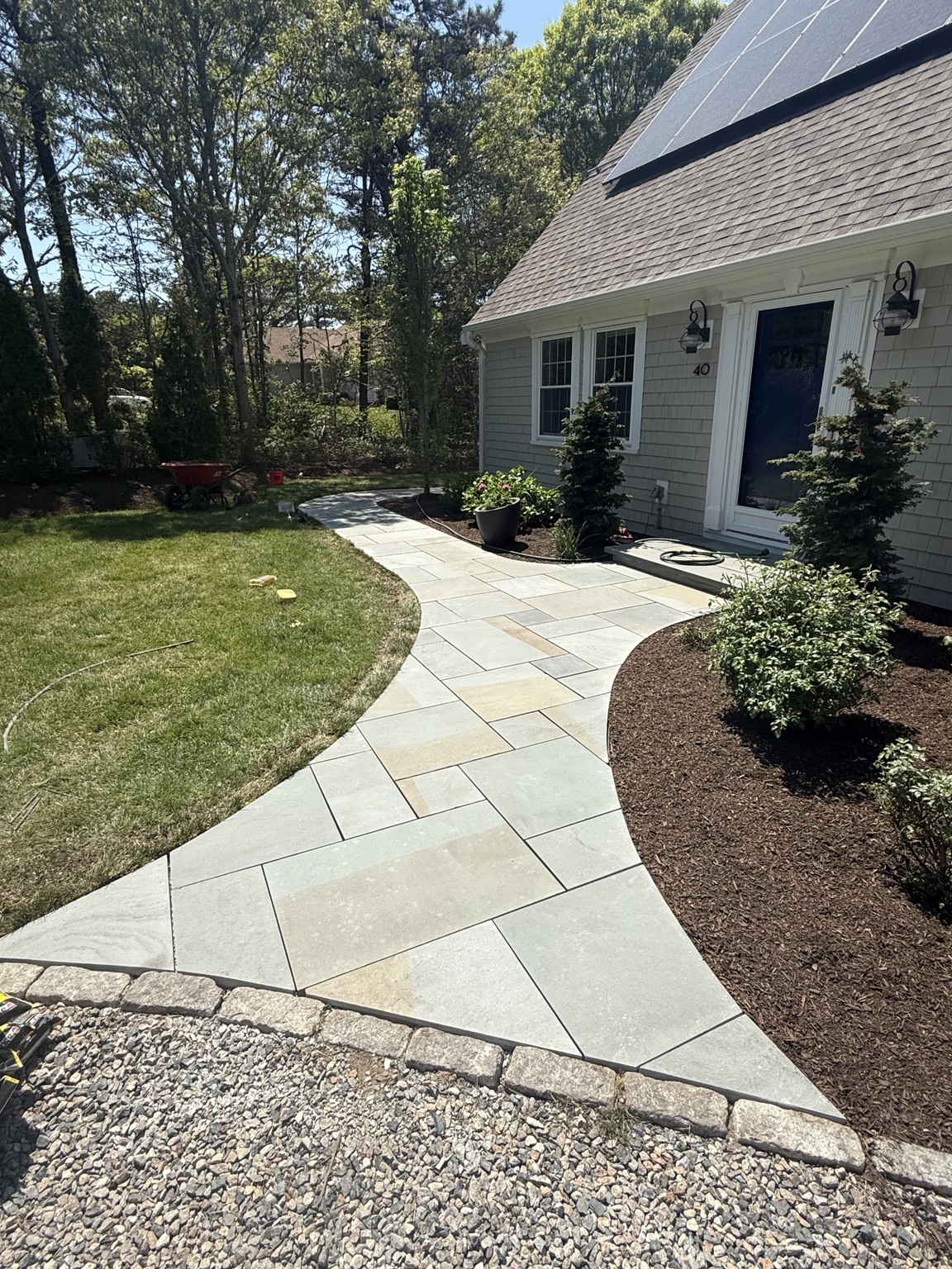 Curved paver walkway and landscaped entrance